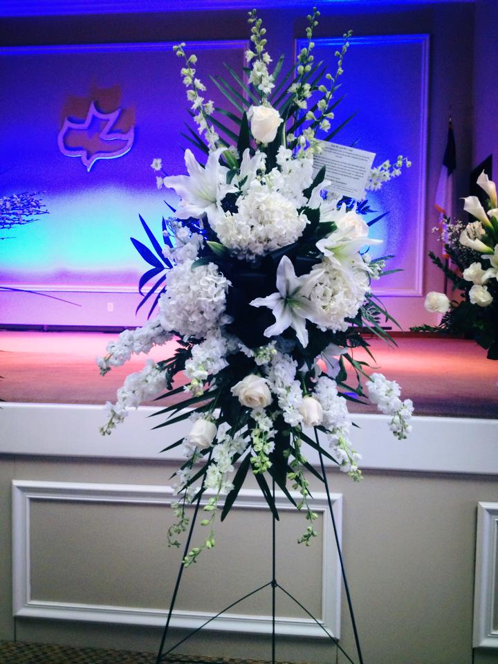 Tall white floral standing spray on an easel