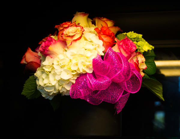 Bouquet of roses and hydrangeas with a bright pink ribbon