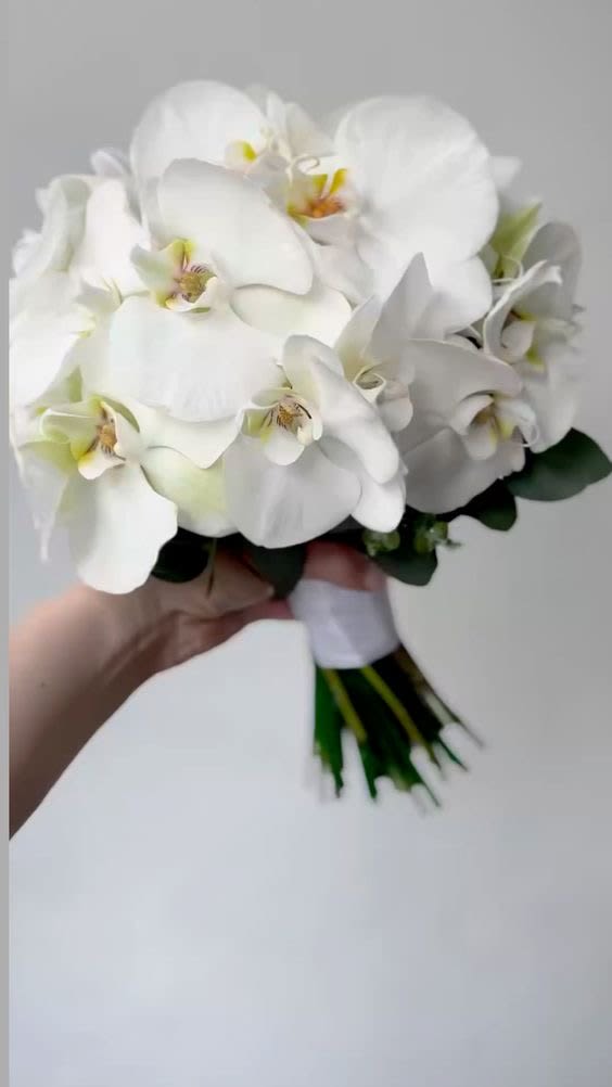 White orchid bouquet with a wrapped stem bundle