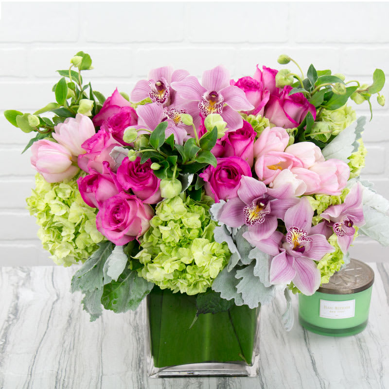 Ooo La-La! - With a charm and beauty all its own, our Ooo La-La! arrangement brightens every day. A loose gathering of Orchids, Roses and Hydrangeas creates a fresh-picked look, complete with lush touches of greenery. Hand-designed inside a clear glass vase, it’s a gift that delivers your sentiments in the most delightful way.