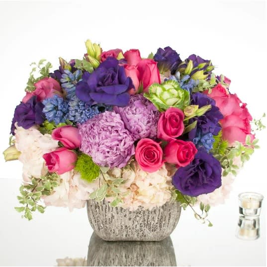 Colorful Sophistication - David Z Designs - This cheery multi-colored mix of a wide variety of seasonal flowers radiates HAPPINESS! A dozen South American Roses, a half-dozen of hydrangeas, and other seasonal flowers in pastels and deep tones come together beautifully in this specialty arrangement. Approx: 16" H