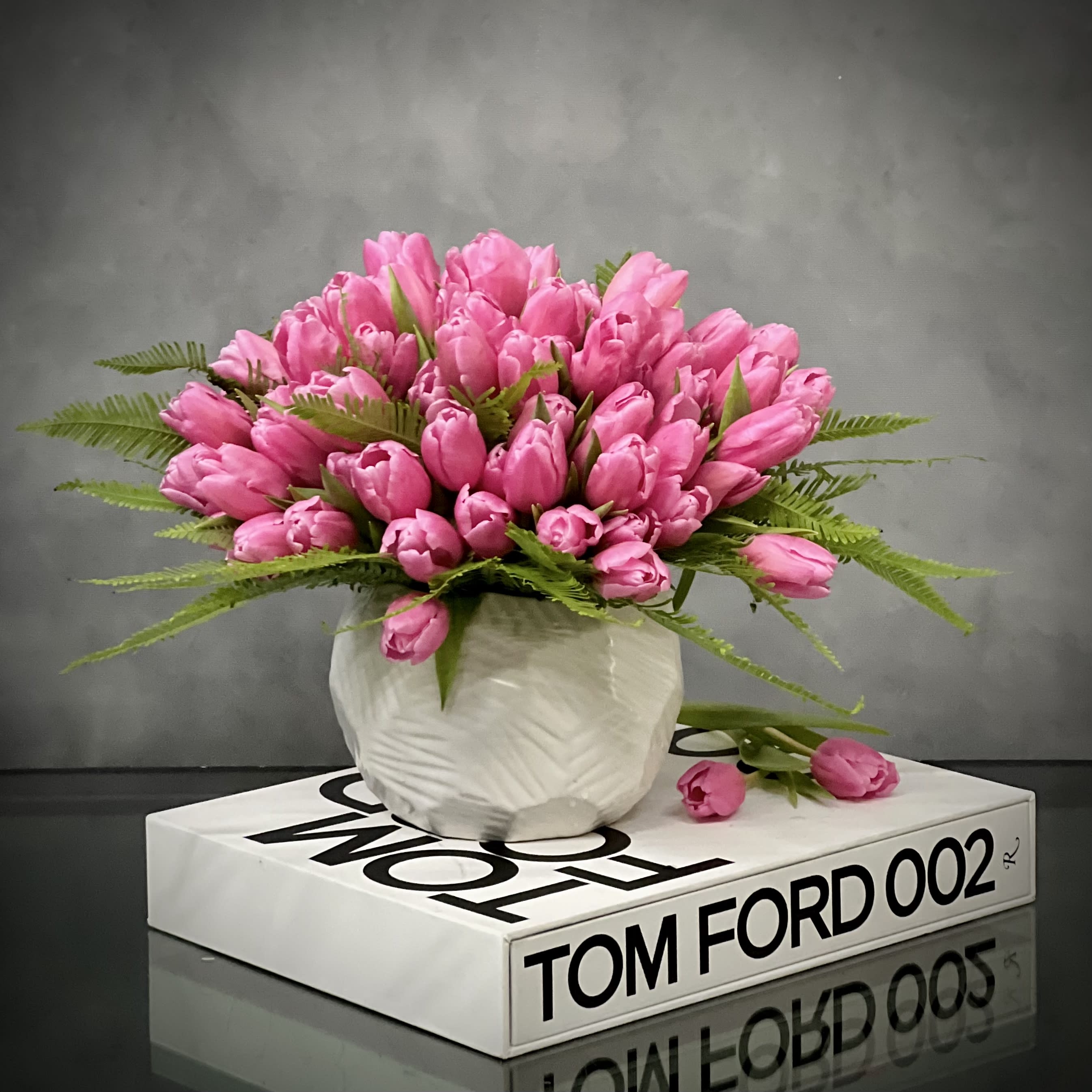 Pink on Ford  - Container May Vary - Simple elegance at it’s best!  A lovely bouquet of about 80 Pink Tulips stand atop beautifully arranged picturesque Modern Vase.  A beautiful expression of your sweetest sentiments!  Measurement   10" Tall and 10" Wide in a 5" Geometric Vase