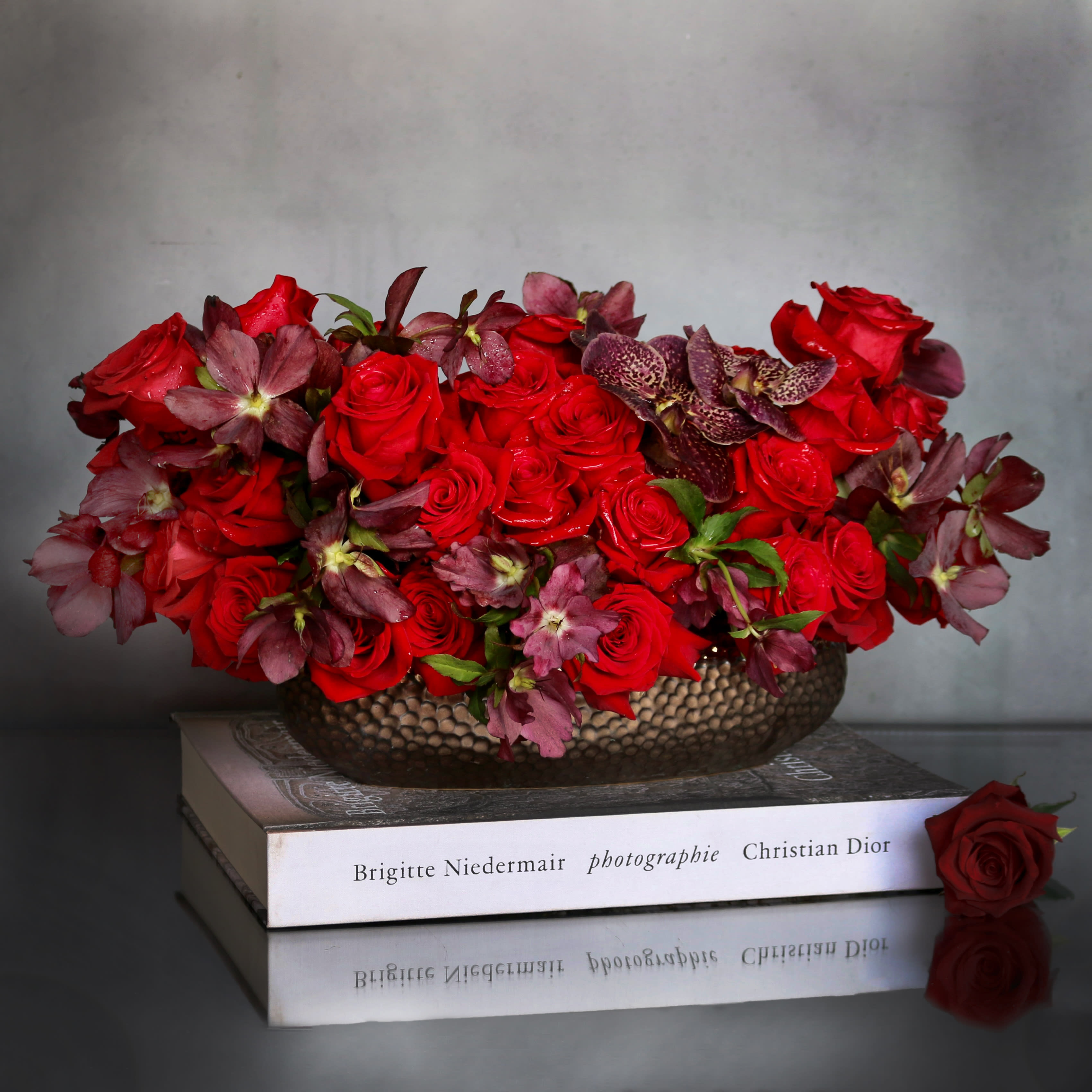 Adore Me  - "Adore Me" is a romantic and rich arrangement filled with beautiful red Roses &amp; Orchids. Arranged within a long ceramic vase. Beautifully made for that someone special !  Measurement:  Vase: 3x11 Arrangement: 9x16 
