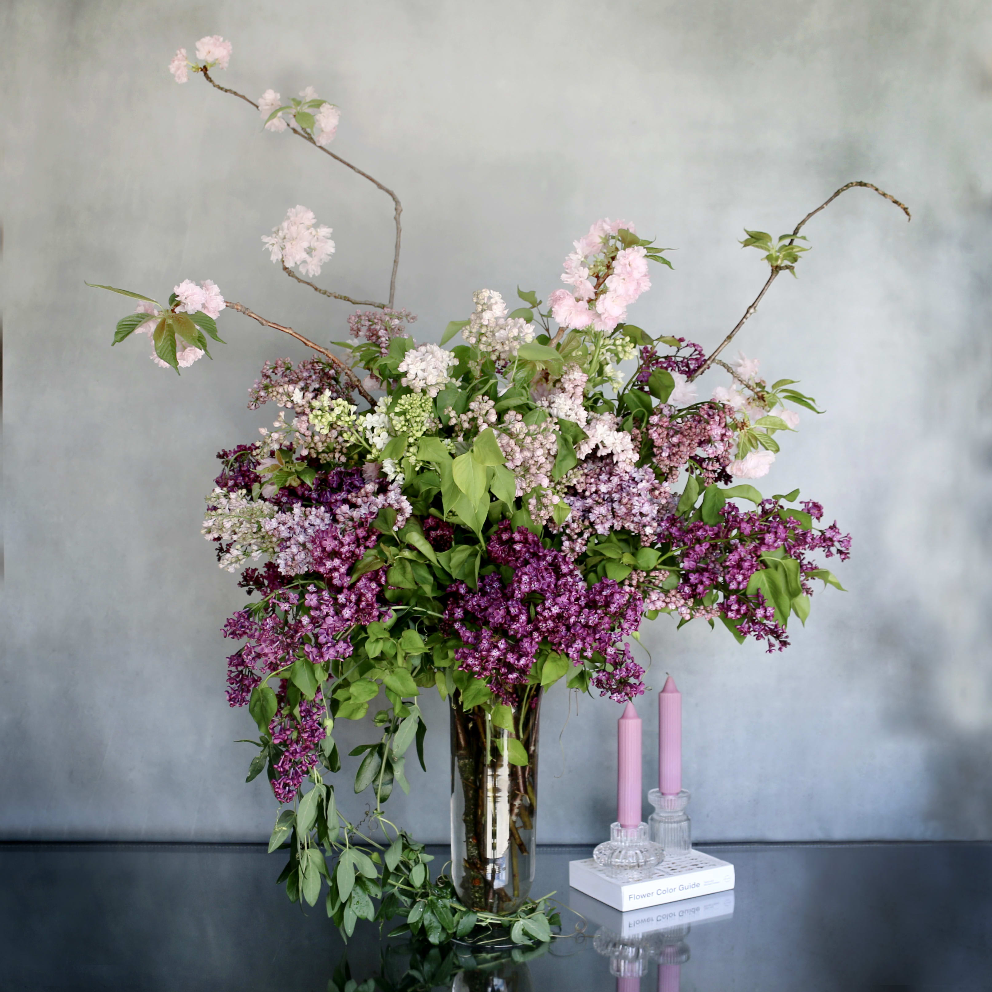 Lilac Standing Tall - Purple shades of lilac paired with cherry blossom makes this arrangement eye catching. It is wonderful on any room setting. 