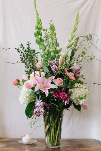 Bountiful Blooms - This showstopper is filled with lush hydrangeas, fragrant stargazer lilies, peonies. lilac (when seasonally available), and dendrobium orchids.  
