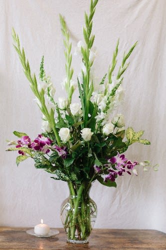 Heartfelt Expressions - White gladiolus, snapdragons, and roses are accented with lavender dendrobium orchids.  This arrangement also makes a stunning sympathy presentation.