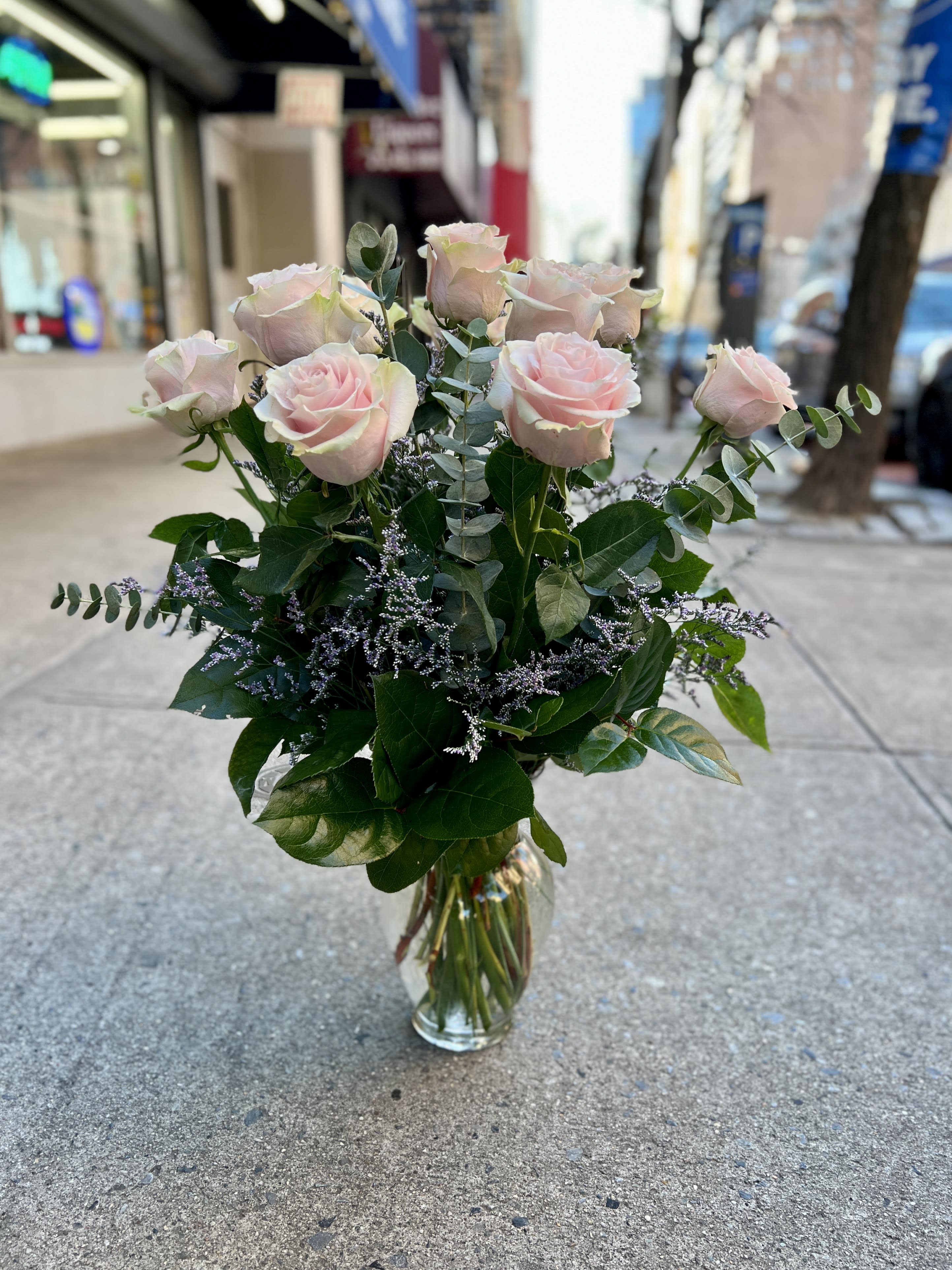Bouquet of pale pink roses in a clear glass vase