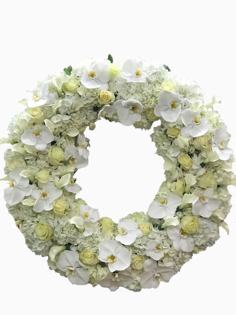 Large white and ivory floral wreath featuring orchids, roses, and hydrangeas