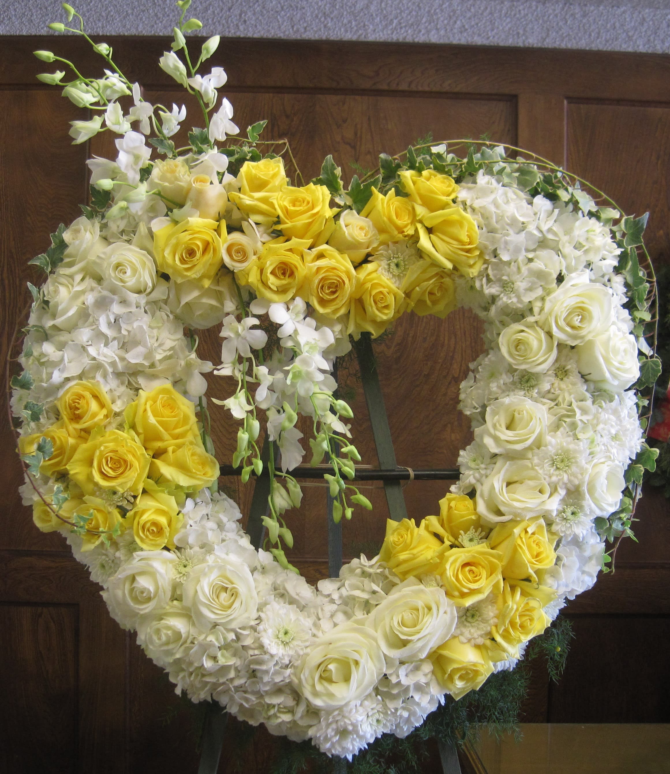 Loving thought Heart Wreath - Open Heart wreath (24") with white hydrangeas, yellow and white roses and white dendrobium orchids