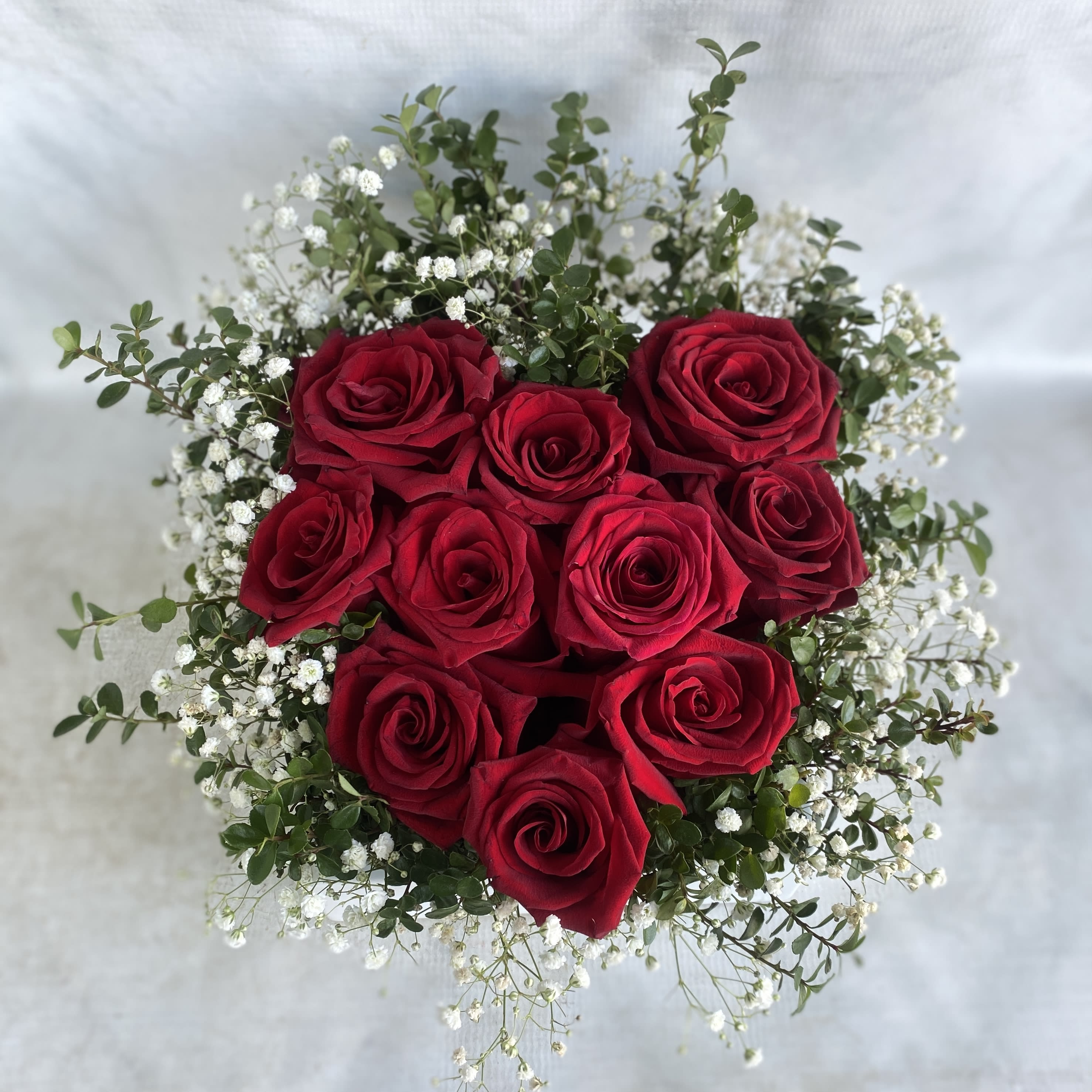 Heart Shaped Roses - A white ceramic container with 10 roses in the shape of a heart.  Say "I Love You" in a special way!