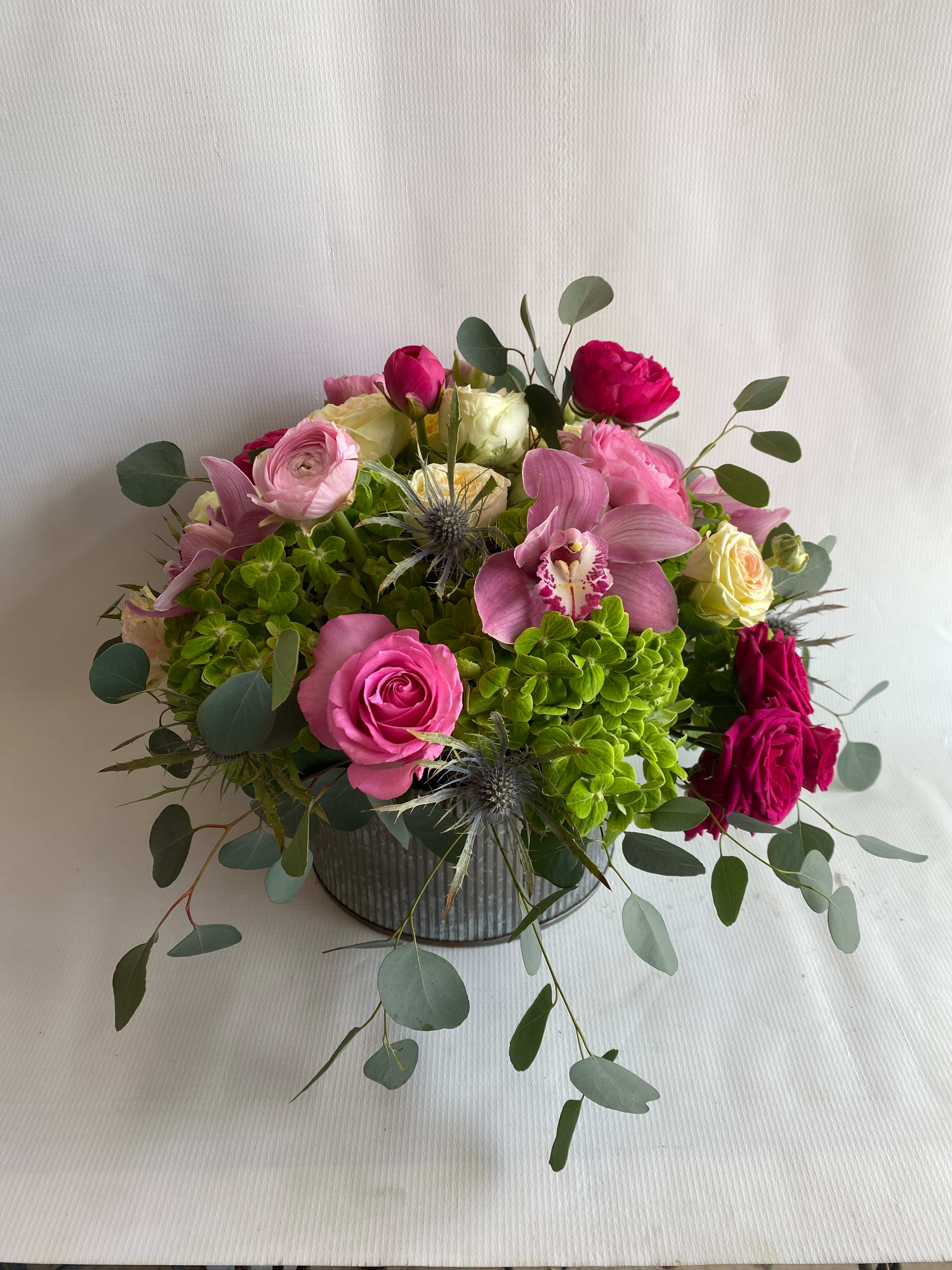 RanucuLove - Experience a burst of vibrant colors with our stunning flower arrangement, featuring a bright mixture of lush hydrangeas, delicate roses, exquisite cymbidium orchids, and charming ranunculus, all artfully arranged in a stylish tin container.  This enchanting arrangement is a true celebration of life and joy, designed to brighten up any setting and bring a smile to your face. The harmonious blend of colors and textures creates a stunning visual display that is sure to impress and delight.  Perfect for any occasion, this arrangement is the ultimate gift for those who appreciate the beauty and vitality of nature. Whether you're celebrating a special occasion or simply want to add a touch of color and cheer to your own decor, this flower arrangement is the perfect choice.  So why wait? Treat yourself or someone special to the irresistible charm and beauty of our tin container arrangement today and experience the magic of flowers like never before.