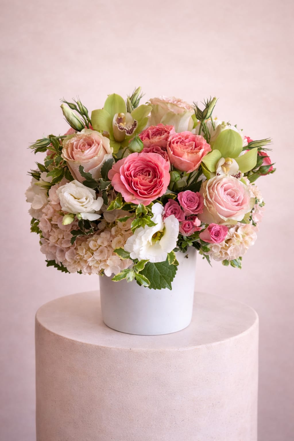 Pink and white floral arrangement in a white vase