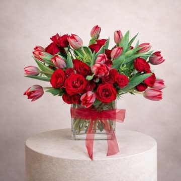 Touching Tulips - 16 red tulips with 6-8 stems of spray roses for a total of approximately 36 blooms!