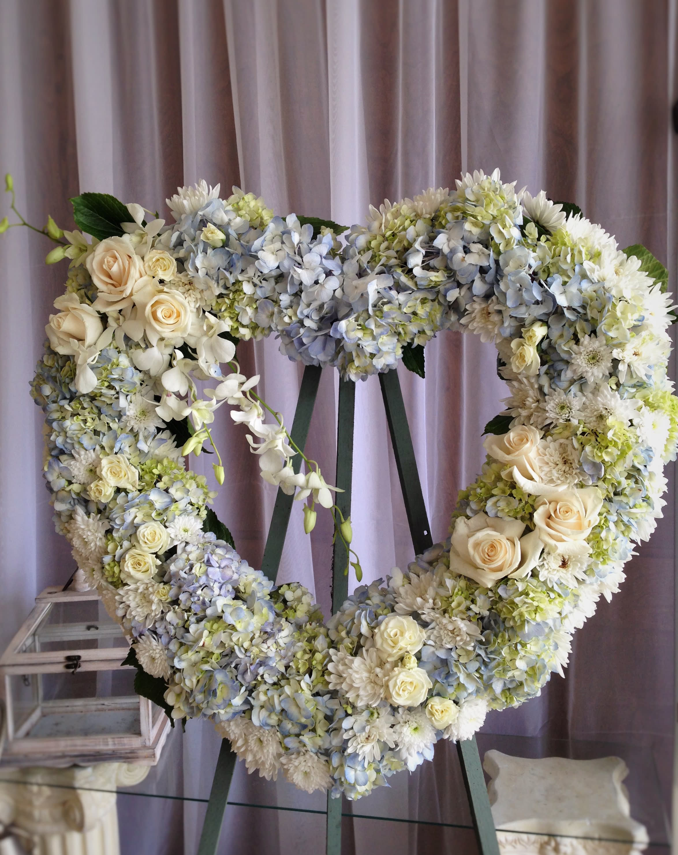 Tranquil Heart Wreath - Open Heart Wreath (24") with White Roses, Cushion Mums, White and Blue Hydrangeas, and dendrobium orchids.