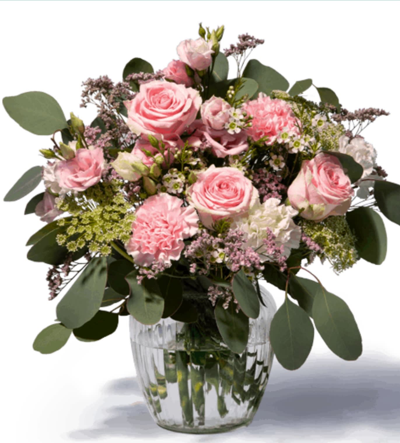 Pink roses and carnations in a clear glass vase