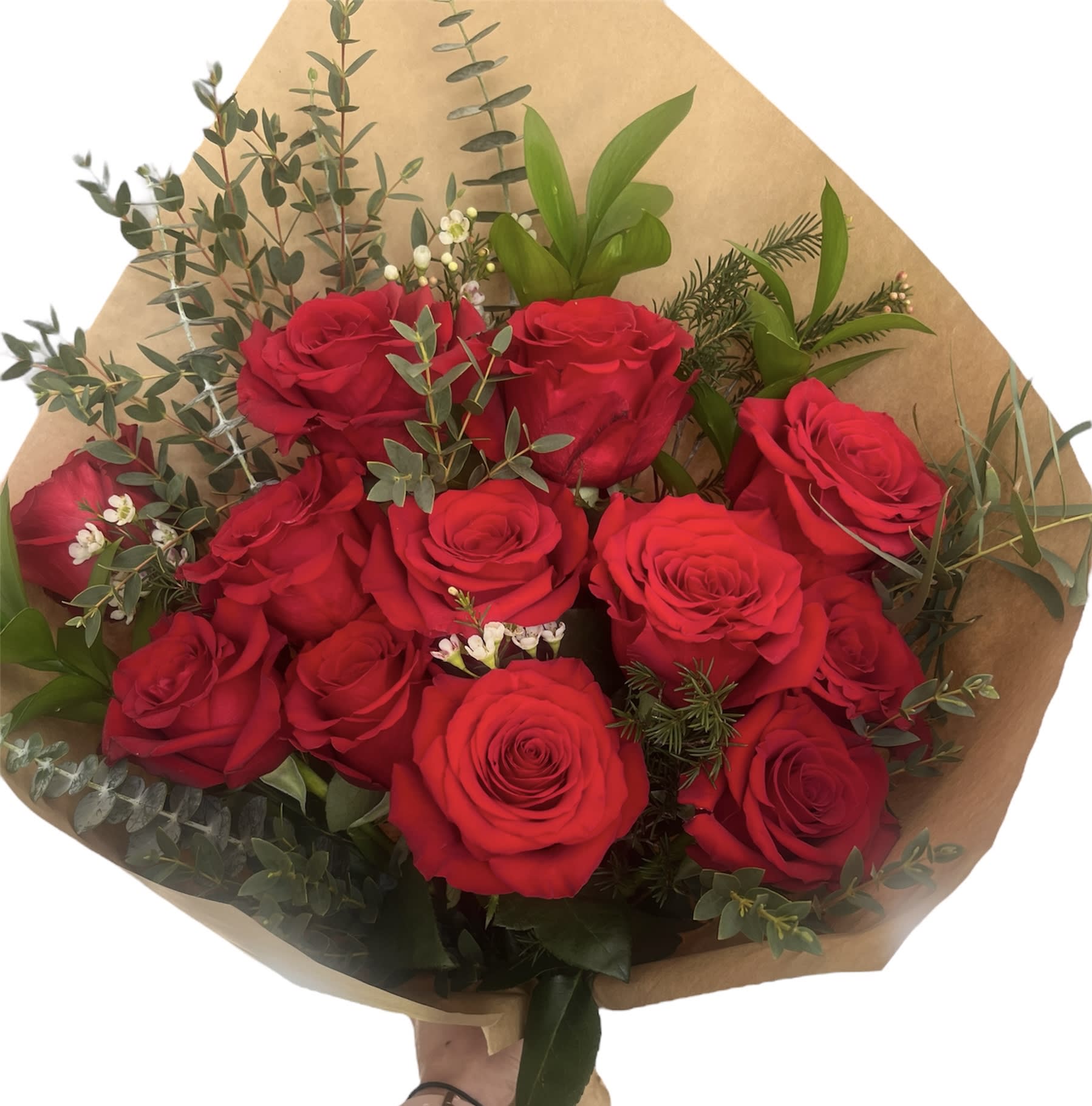Bouquet of red roses with greenery wrapped in brown paper