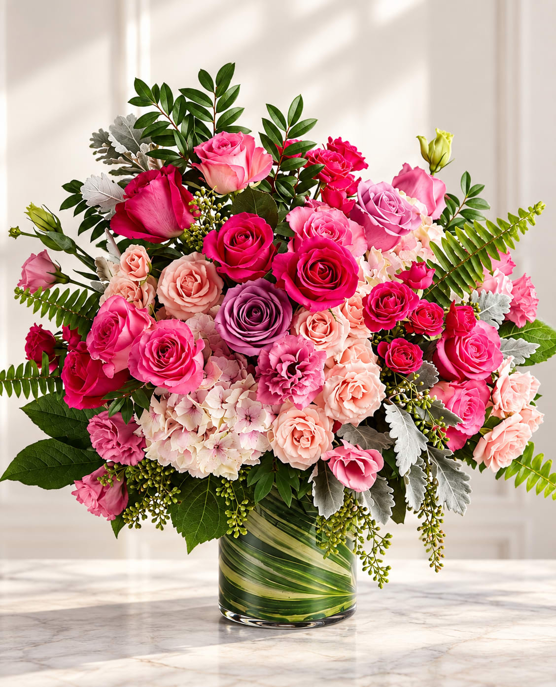 Pink and peach rose bouquet in a glass vase