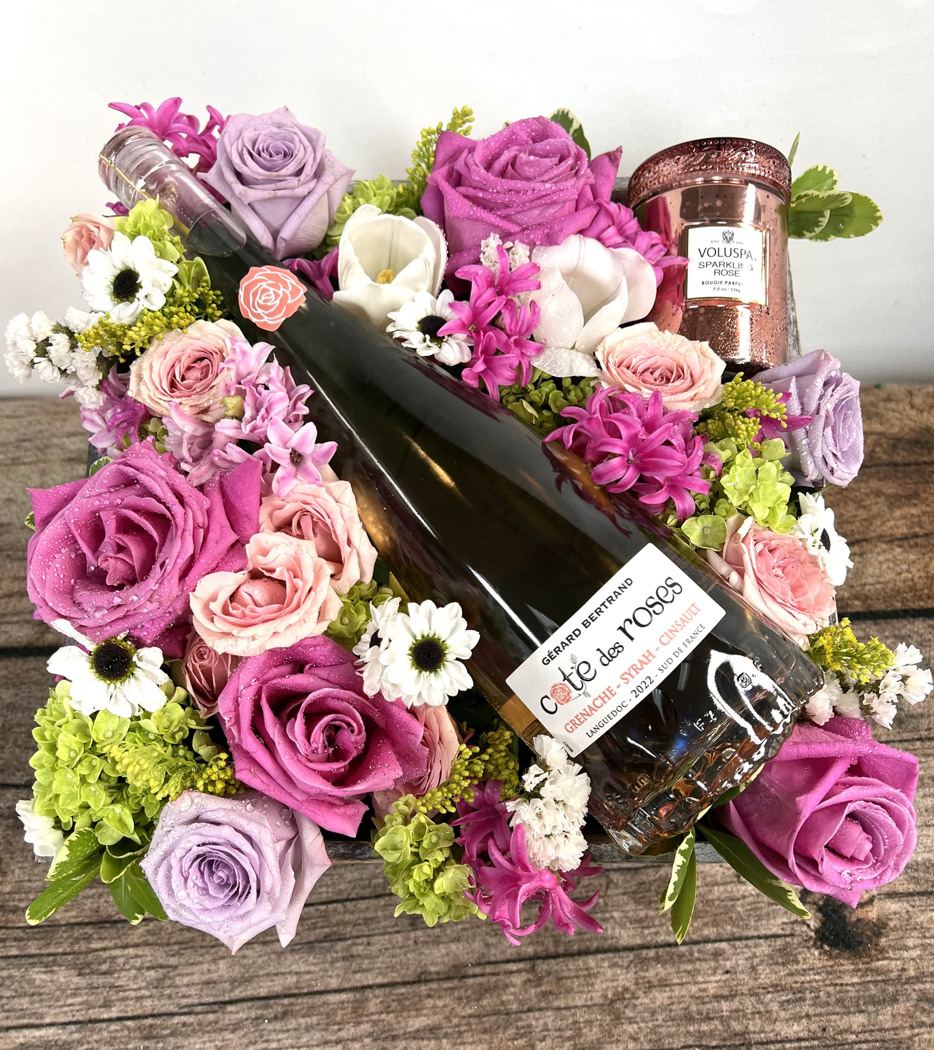 Bouquet with roses and a wine bottle, plus a rose-scented candle
