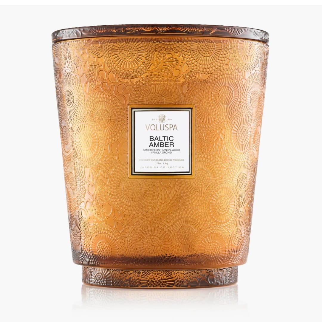 Amber decorative candle jar with a labeled front
