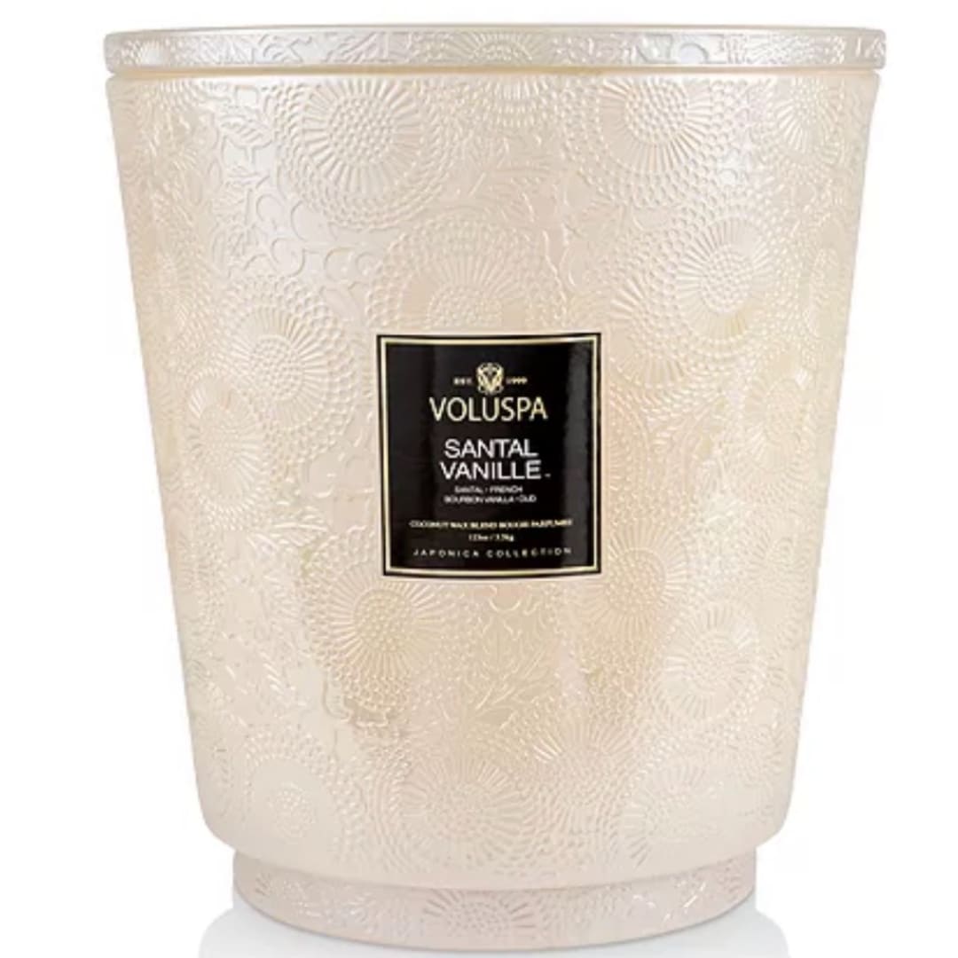 Cream-colored Voluspa candle in an embossed glass jar