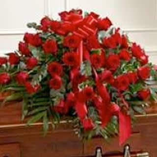 Large arrangement of red roses with a red ribbon