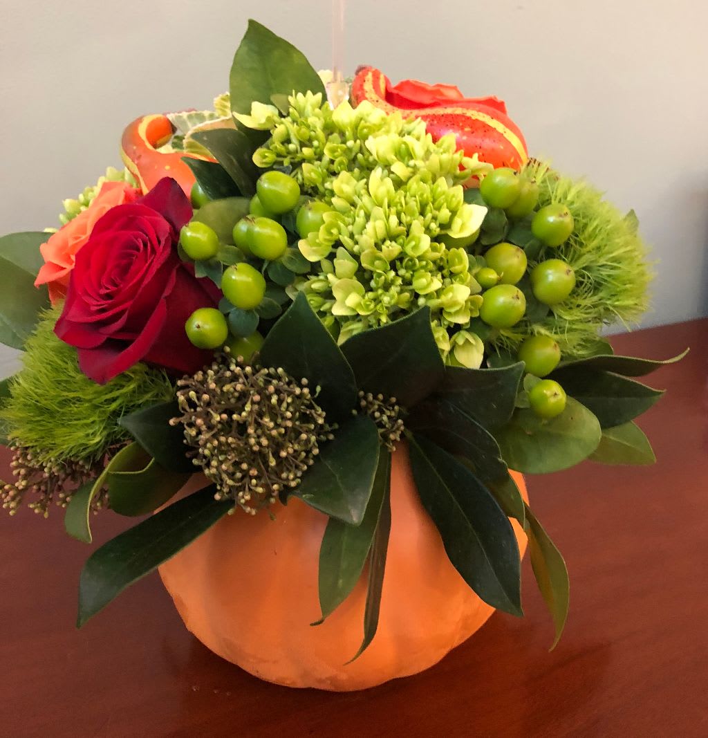Pumpkin Spice - Pumpkin Spice | Wilmington, Delaware Florist  Welcome the cozy season with Pumpkin Spice, a festive fall arrangement handcrafted by Petals Flowers and Fine Gifts in Wilmington, Delaware. Designed in a vibrant orange ceramic pumpkin, this autumn centerpiece features lush green hydrangea, textured green trichilium, seasonal green hypericum berries, bold dark red roses, and radiant orange roses, accented with charming faux pumpkins for a touch of harvest flair.  As your trusted local florist in Wilmington, Delaware, we take pride in using premium flowers and offering same-day, tax-free delivery throughout Wilmington, Hockessin, Newark, Chadds Ford, Glen Mills, Kennett Square, and surrounding communities.  Why Choose Us? * Custom, luxury floral designs with guaranteed freshness * Family-owned flower shop in North Wilmington, Delaware * Same-day flower delivery for homes, businesses, and events 