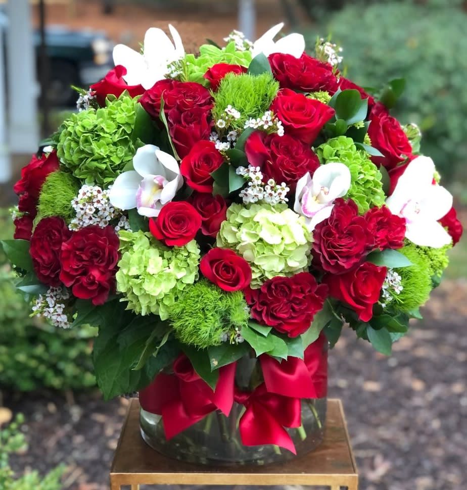 Love Affair - Love Affair | Wilmington, Delaware Florist  Ignite passion and romance with our stunning Love Affair arrangement, exclusively designed by Petals Flowers and Fine Gifts — your trusted local florist in Wilmington, Delaware. This luxurious floral display features an abundance of velvety red roses paired with lush green hydrangea, delicate green trichilium, and elegant orchids. Artfully arranged in a clear glass cylinder and finished with a rich red satin bow, Love Affair is the perfect expression of love, admiration, and timeless elegance.  Ideal for anniversaries, romantic surprises, Valentine’s Day, or simply to show someone special how much they mean to you, this arrangement combines classic beauty with fresh, modern style to create an unforgettable statement.  As a boutique flower shop in Wilmington, Delaware, we take pride in crafting custom, premium floral designs using only the finest blooms. We offer same-day, tax-free flower delivery throughout Wilmington, Hockessin, Newark, Glen Mills, Chadds Ford, Kennett Square, and surrounding communities — always backed by our satisfaction guarantee.  Why Choose Us?  * Locally owned Wilmington florist known for creative, high-quality floral arrangements * Personalized service and attention to every detail * Reliable same-day delivery to homes, offices, and event venues across the area Order Love Affair today and let us deliver a breathtaking floral experience right to your loved one’s doorstep in Wilmington, Delaware.