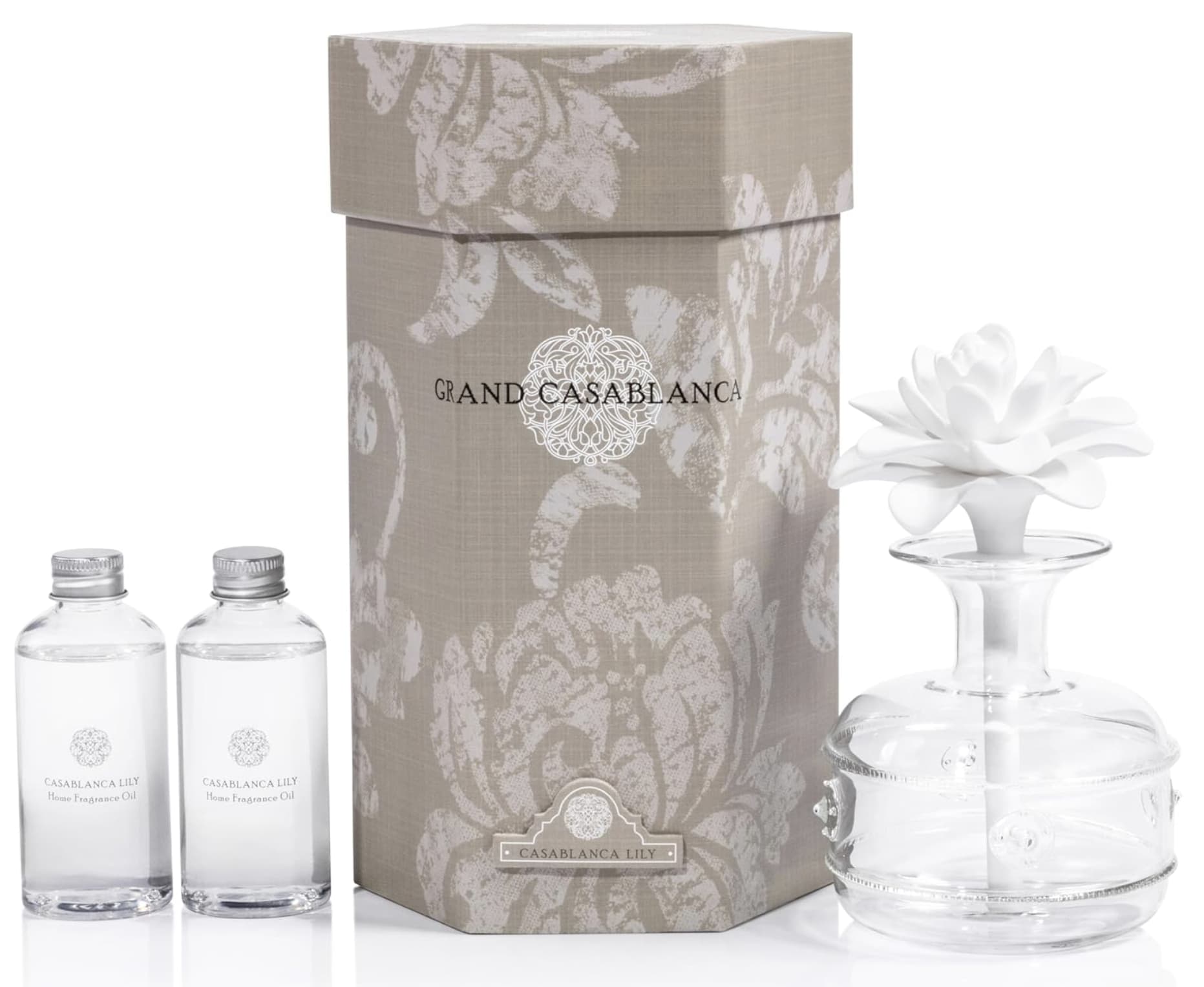 Zodax Grand Casablanca Porcelain Diffuser: Casablanca Lily - Casablanca Lily with notes of assorted fresh lilies. Its elegant and beautiful design makes it the perfect decor for any room. Set includes one glass bottle, one porcelain flower and two bottles of oil. Tax free. Same day hand delivery.