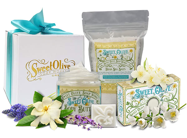 Sweet Olive Soap Works gift set with boxed bath products and flower decorations