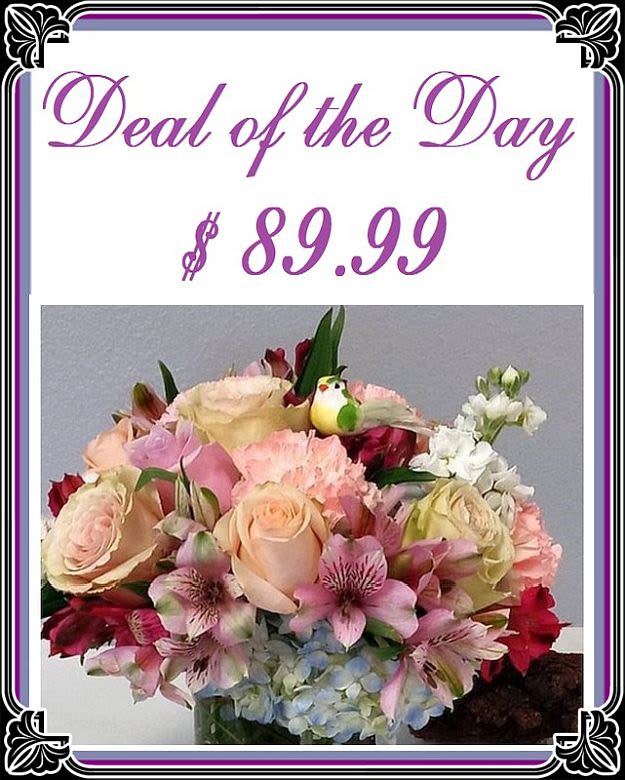 Mixed bouquet of roses, lilies, and hydrangeas in a vase