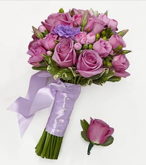 Pink and lavender rose bouquet with a ribbon-wrapped handle and matching boutonniere