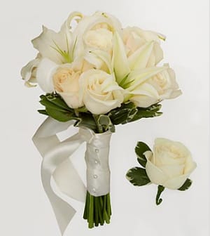 White rose and lily bouquet with a satin ribbon and matching boutonniere