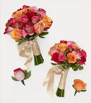 Two rose bouquets and two rose boutonnieres with cream ribbons