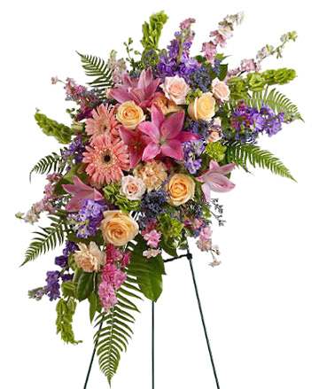 Tall floral standing spray with pink lilies, roses, and purple flowers