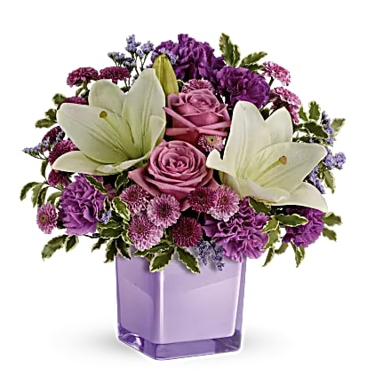 Purple bouquet with white lilies and pink roses in a lavender vase
