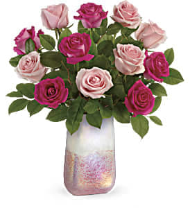 Pink and magenta roses in a tall iridescent vase