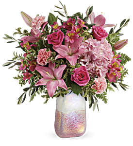 Pink mixed bouquet in a iridescent glass vase