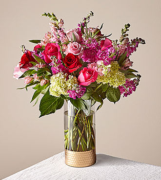 Pink and red rose bouquet in a clear glass vase