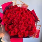 Large bouquet of red roses wrapped in pink and burgundy paper