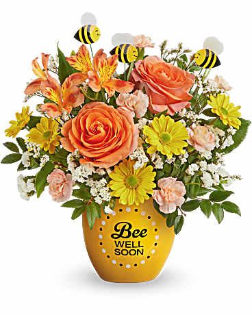 Orange and yellow flower arrangement in a bee-themed pot with bee picks