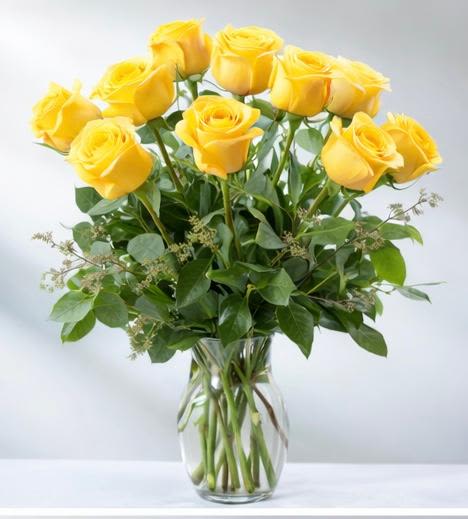 Yellow Rose Bouquet - Nothing speaks of love so much as a bouquet of beautiful roses. Arranged in a classic glass vase, this bouquet is a gift to her heart from yours. Standard rose bouquet includes 12 stems, approximately 18"H x 12"W, Deluxe rose bouquet includes 18 stems, approximately 19"H x 16"W, premium rose bouquet includes 24 stems, approximately 20"H x 18"W. 