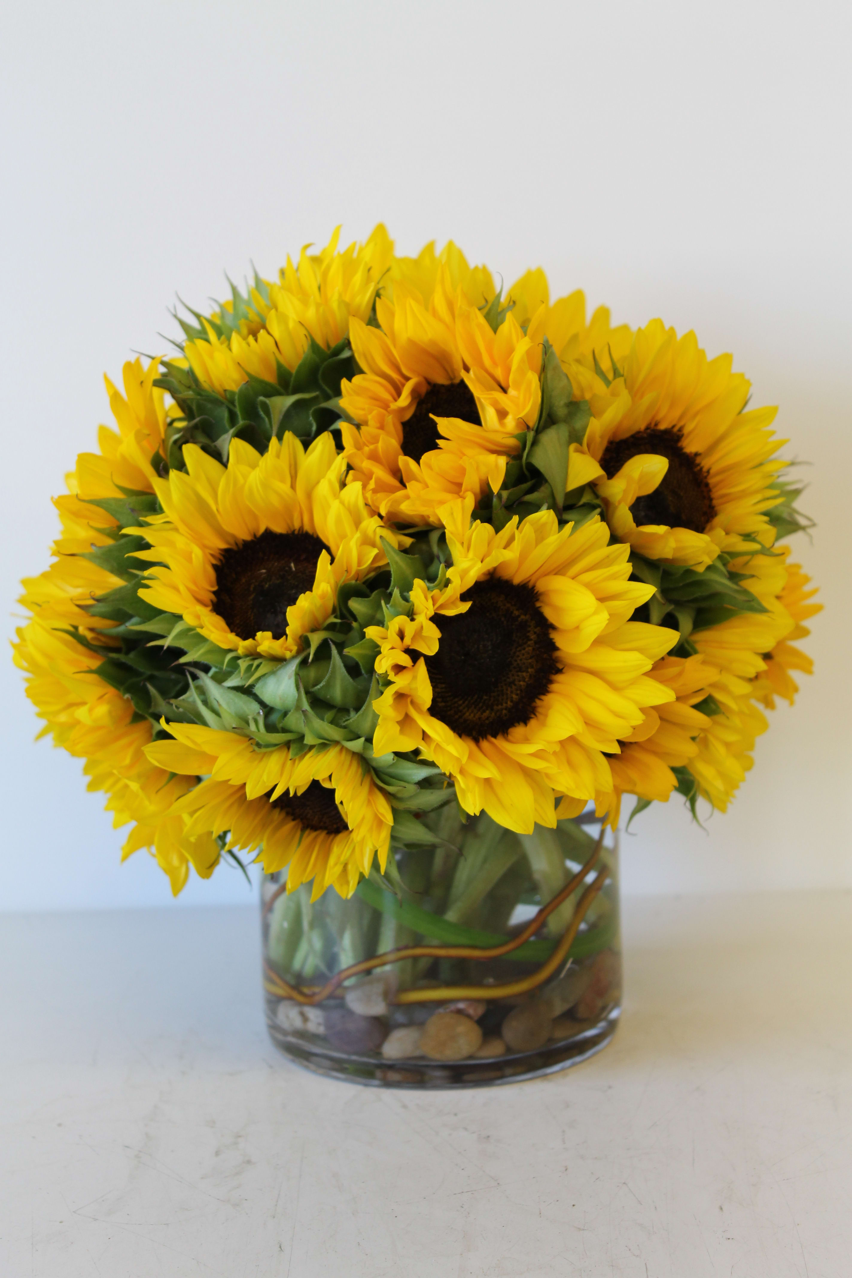 Bouquet of yellow sunflowers in a glass vase