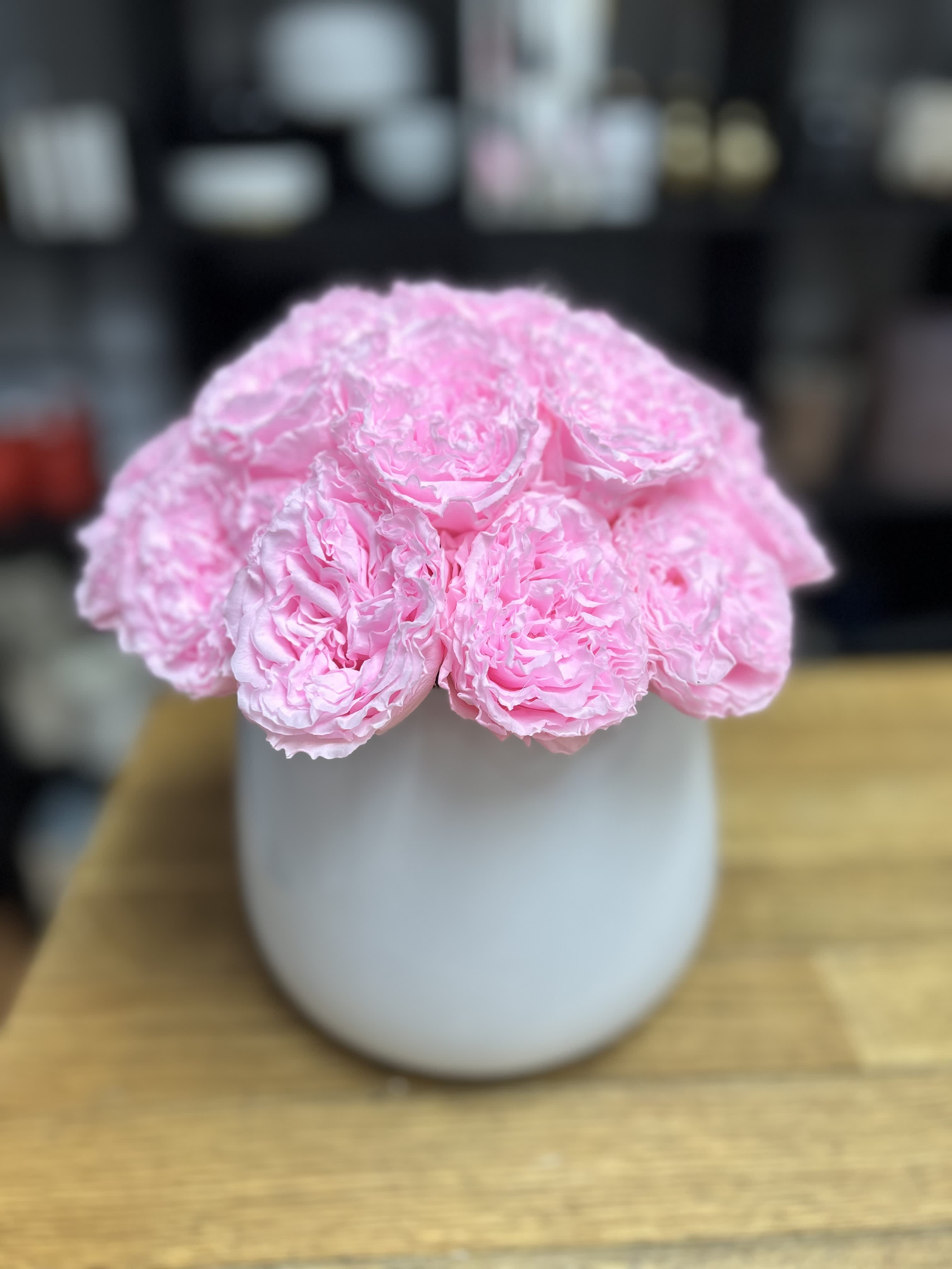 Pink peonies arranged in a white vase