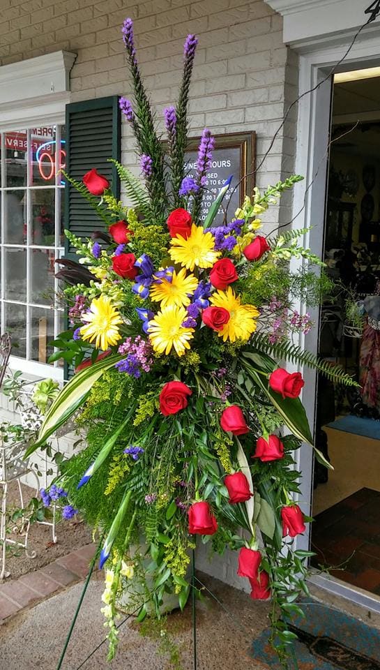 Timeless Beauty - A beautiful tribute that consist of Red Roses, Purple Iris, Gerber Daisies, Snapdragons and other filler flowers all designed on a 60" easel. 