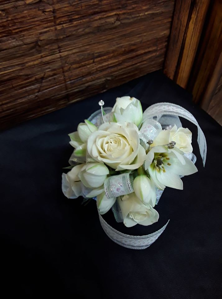Roses, Tulps and everything nice wristlett corsage - A beautiful white wristlett corsage designed with white spray roses, white tulips and other blooms with a rinestone braclett. Perfect for any special occasion. 