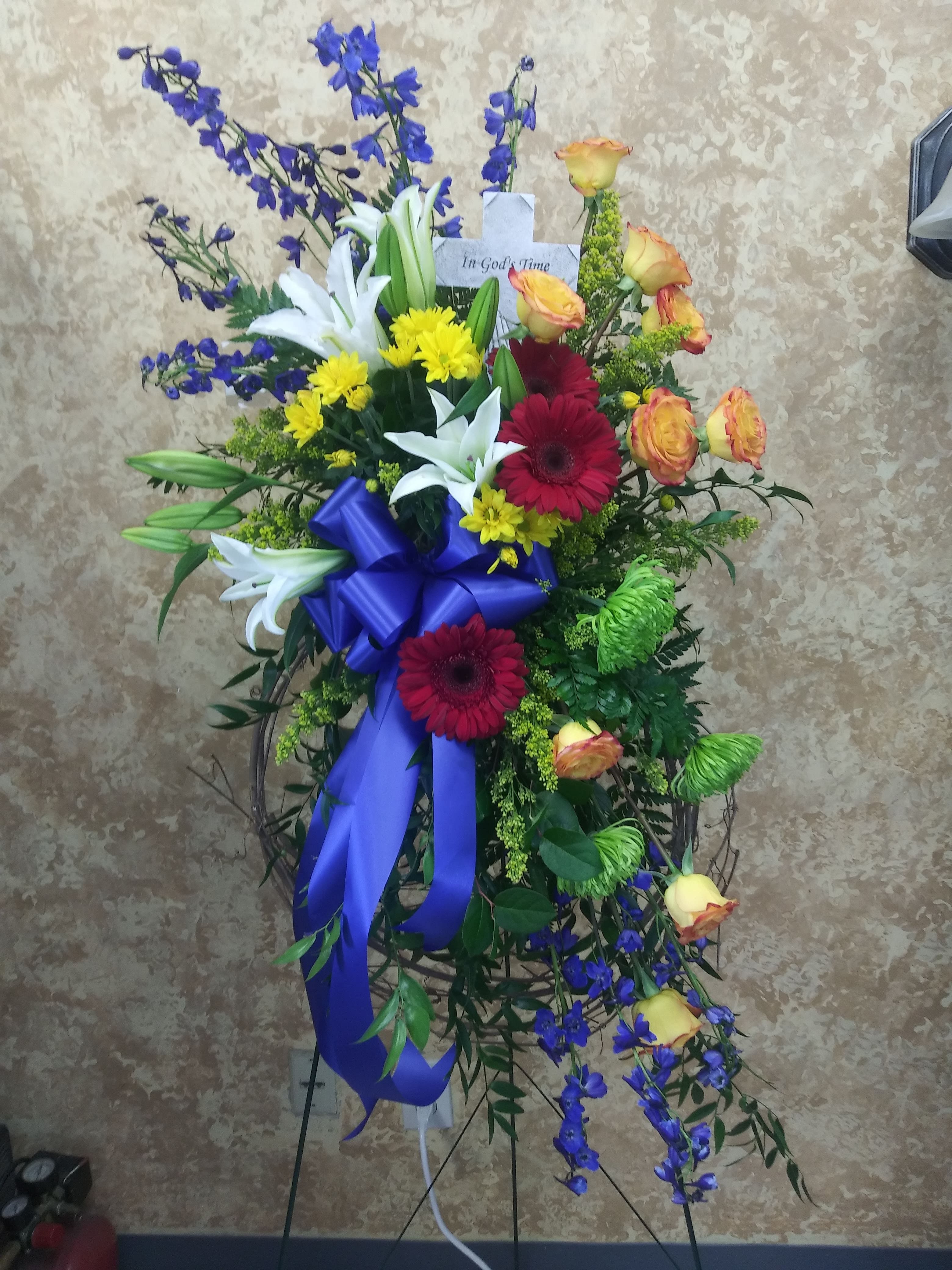 Standing sympathy spray with lilies, roses, and gerbera daisies