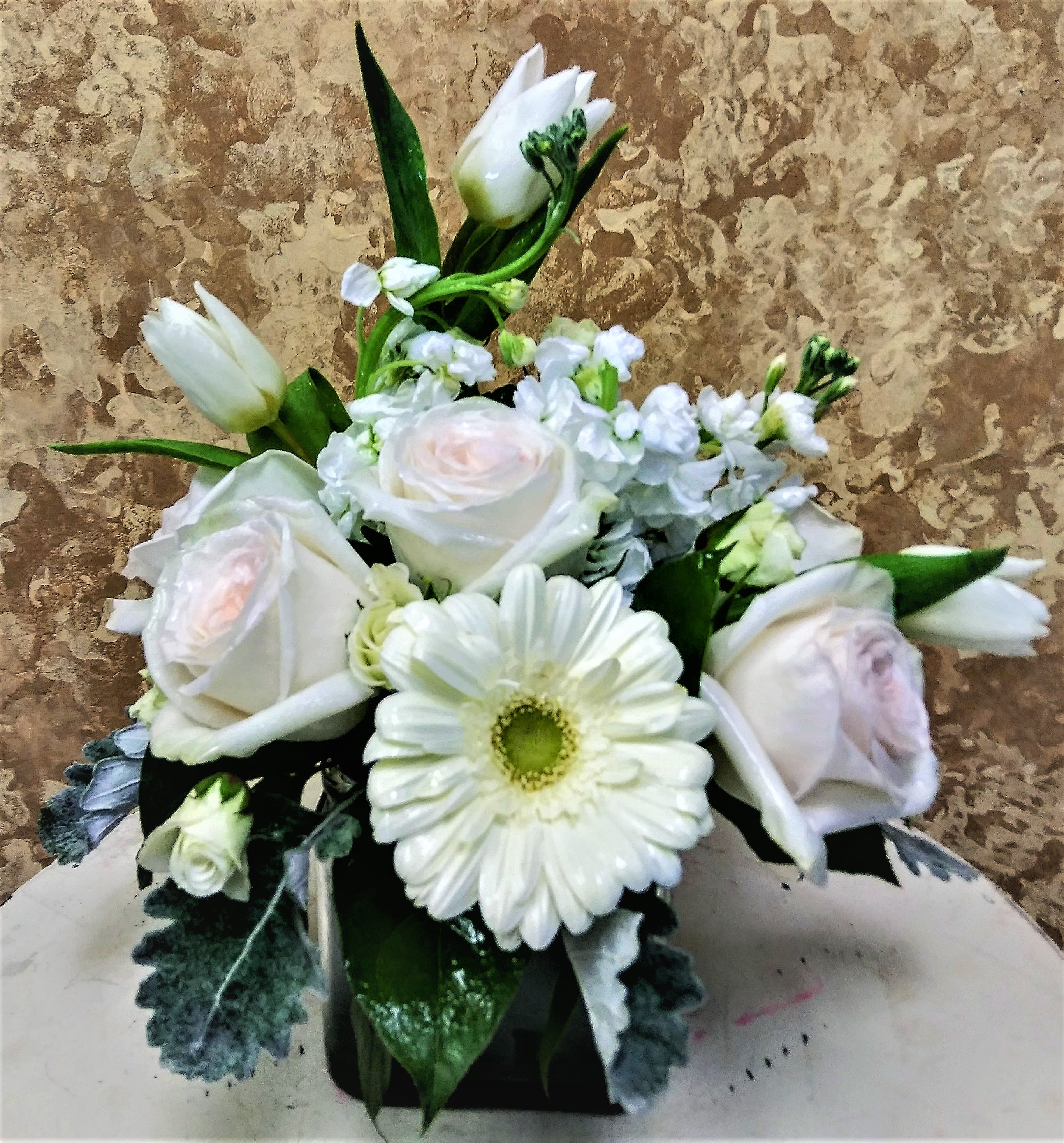 Symplicity - The symplicity of this arrangement captures the simple thngs in life with its colors of whites and pastel roses.  