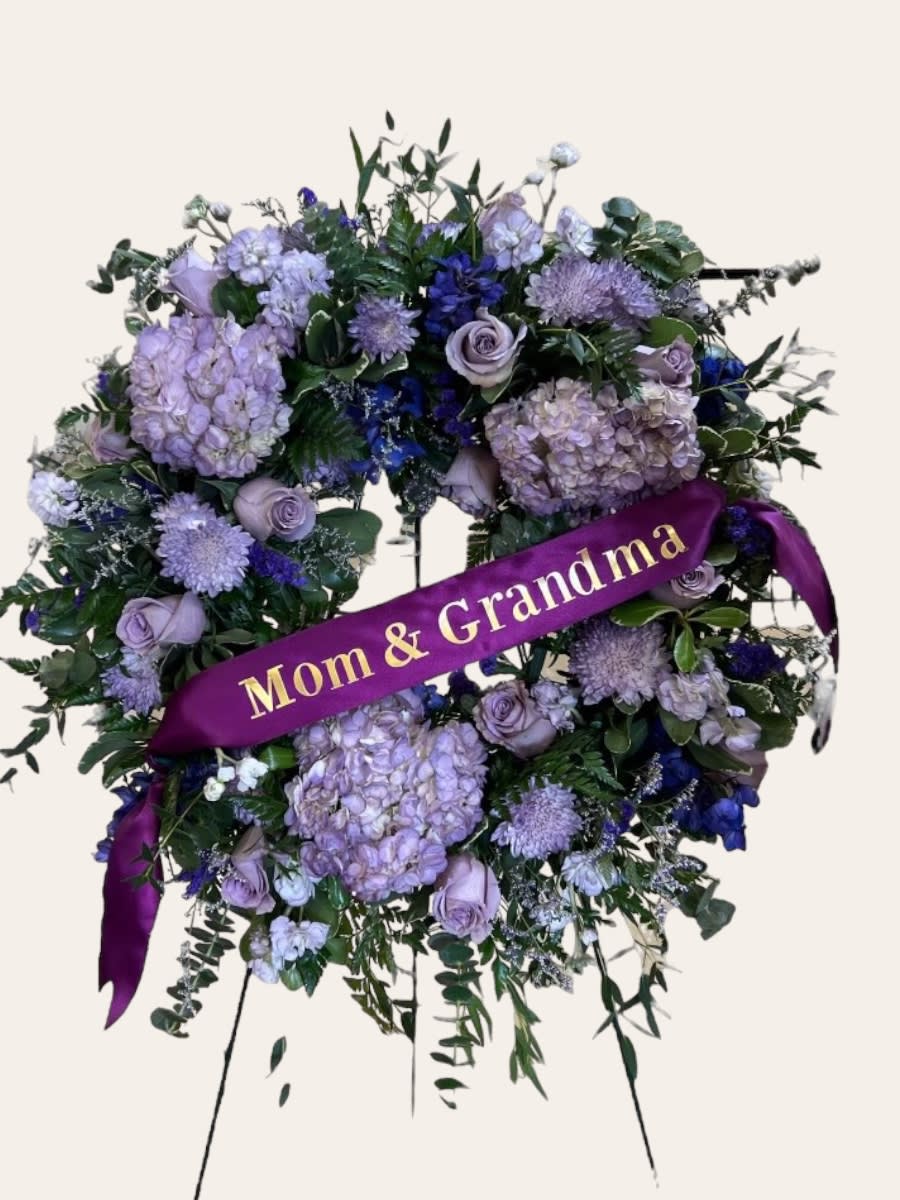 Purple floral standing wreath with a "Mom &amp; Grandma" ribbon