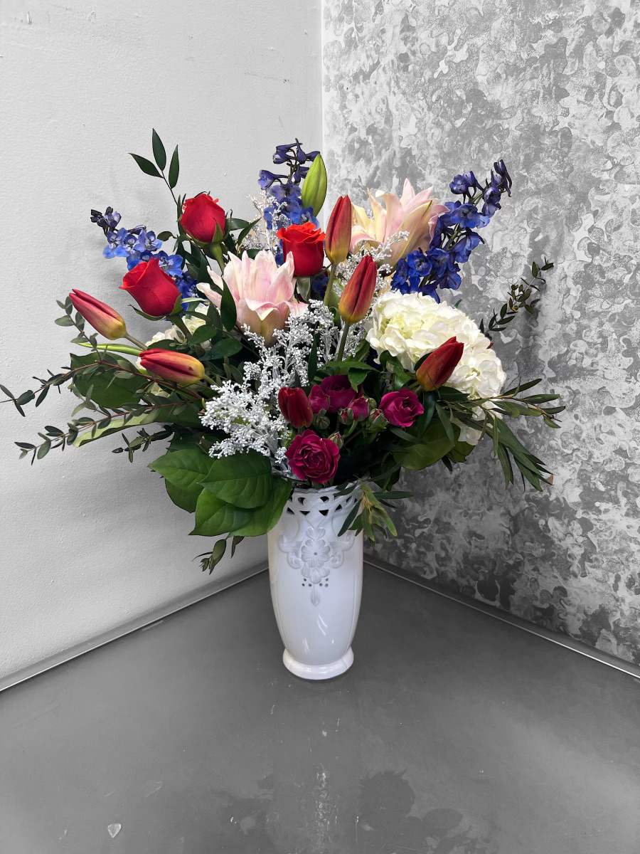 Sadie - What a way to celebrate any occasion for that special someone in your life. This arrangement is designed in a white ceramic container with tulips, hydrangeas, spray roses, and other blooms.