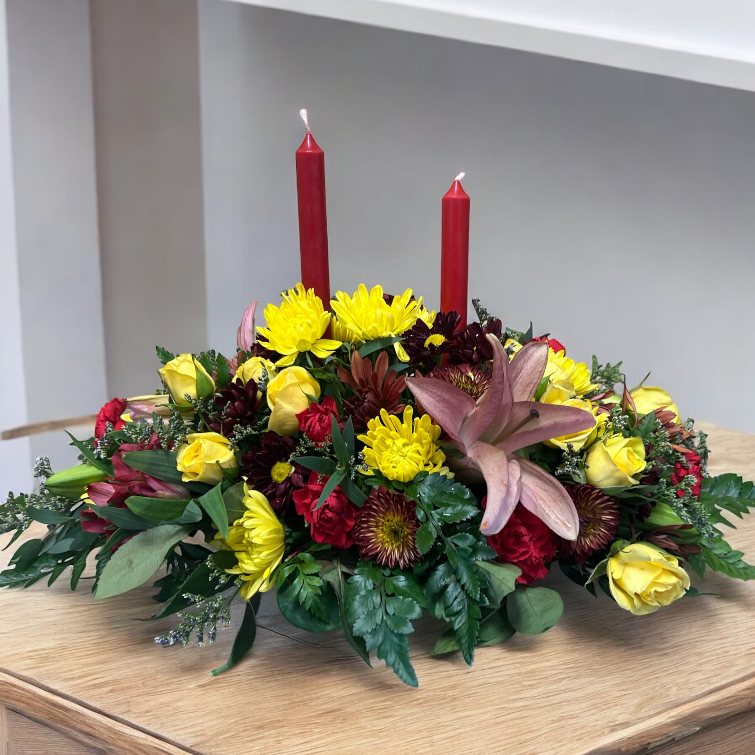 Harvest Elegance  - Large Beautiful centerpiece designed for your Holiday table! Have family and friends gather around this beautiful arrangement. With candles to light during the gathering. With lilies, roses, mums and Lucious greens